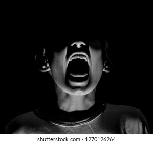 Portrait of young screaming girl. Scary and fear concept. Low key lighting, black and white shot. Isolated on black. - Shutterstock ID 1270126264