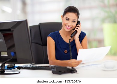 portrait of young secretary answering telephone