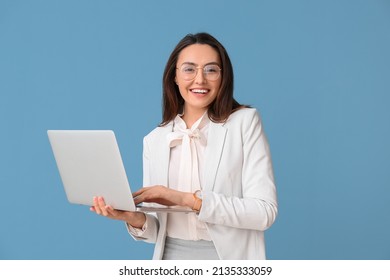 Portrait of young secretary with laptop on blue background - Shutterstock ID 2135333059