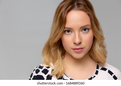 Portrait Of A Young Serious Woman Standing Monochromatic Background