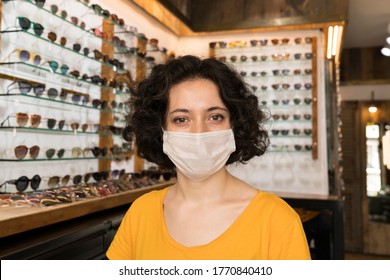 Portrait Of Young Small Business Woman Owner With Face Mask At Store