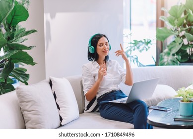 Portrait of Young Smart Caucasian Woman Freelance Online Working from Home with Laptop and Relaxing with Music in Break Time at Home Living Room Among Coronavirus Outbreak - Lifestyle Concept