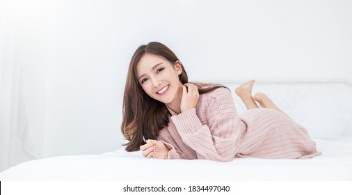 Portrait Young Smile Happy Beautiful Innocence Asian Woman Relax Bedroom. Asian Girl In Winter Cloth. Beauty Long Hair Woman With Perfect Clear Cosmetology Skin. Japanese Girl Makeup Hygge Lifestyle