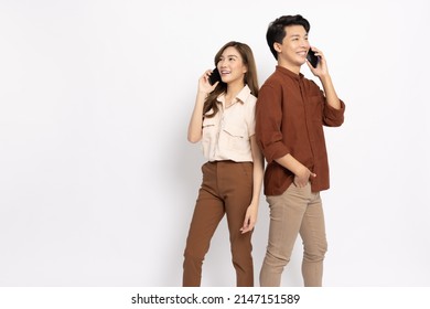 Portrait of young smiling Asian couple talking on smartphone  isolated on white background, Asian Thai model - Powered by Shutterstock