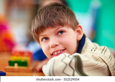 portrait of young smiling boy, kid with disabilities