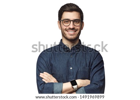 Portrait of young smiling caucasian man with crossed arms, wearing smart watch and casual denim shirt, isolated on white 