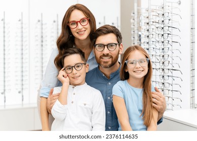 Portrait of young smiling family hugging choosing stylish glasses in modern optical store. Vision concept  - Powered by Shutterstock