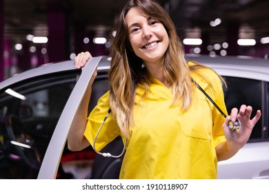 Portrait Of Young Smiling Female Nurse Getting Out Of Her Vehicle Ready To Start Work. Space For Text.