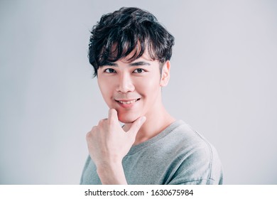  portrait of young smiling handsome man isolated on gray background