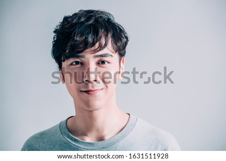  portrait of young smiling handsome man isolated on gray background