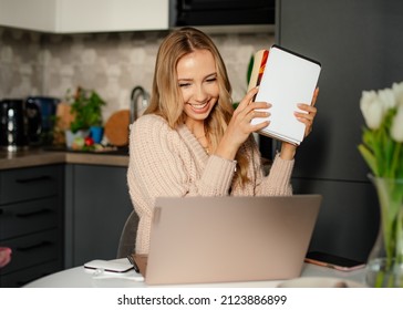 Portrait Of Young Smiling Pretty Woman With Long Wavy Fair Hair In Beige Sweater Talking On Webcam Virtual Conversation.