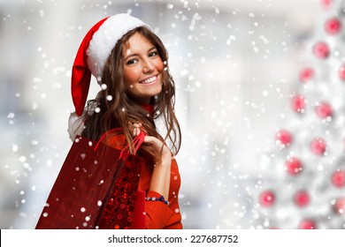 Portrait of a young smiling woman doing shopping before christmas - Powered by Shutterstock