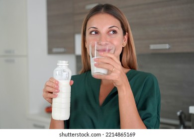 Portrait Of Young Smiling Woman Drinking Kefir. Beautiful Girl Holds A Glass Of Milk In The Morning.