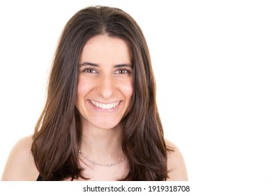 Portrait Of Young Smiling Woman Looks In Camera Over White Wall Copy Space Background