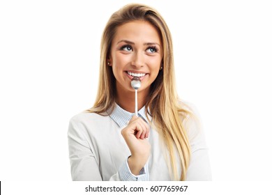 Portrait Of Young Smiling Woman With Spoon In Her Mouth Isolated On White