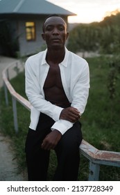 Portrait Of A Young South American Man Leaning On A Fence On Sunset