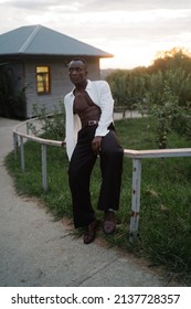 Portrait Of A Young South American Man Leaning On A Fence On Sunset