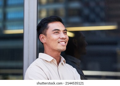 Portrait Of A Young South East Asian Businessman Outside An Office Window