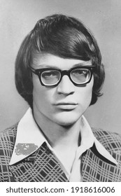 Portrait Of Young Soviet Guy With Glasses, In Checkered Jacket. Vintage Black And White Paper Photo, 1970s. Transferred Property, Family Archive. Outdated Quality.