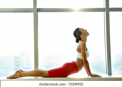 Portrait of young sporty girl doing stretching exercise - Powered by Shutterstock