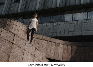 Portrait Of Young Sporty Parkour Woman. Freeruning Female Athlete Standing On Roof.