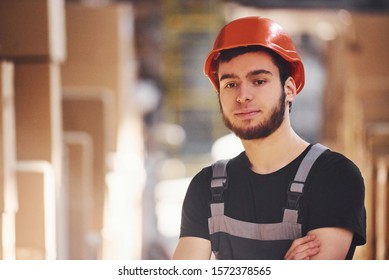 Portrait Of Young Storage Worker In Warehouse In Uniform And Hard Hat.