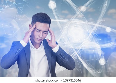 Portrait Of Young Stressed Asian Scientist Over Blurred City Background With Atom Hologram. Concept Of Tiresome Scientific Research. Toned Image Double Exposure