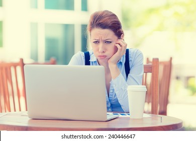 Portrait Young Stressed Displeased Worried Business Woman Sitting In Front Of Laptop Computer Isolated Outdoors City Background. Negative Face Expression Emotion Feelings Problem Perception