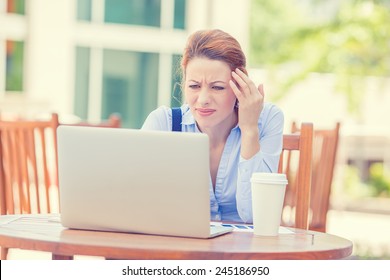 Portrait Young Stressed Displeased Worried Business Woman Sitting In Front Of Laptop Computer Isolated Outdoors City Background. Negative Face Expression Emotion Feelings Problem Perception