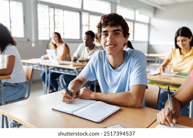 Portrait of young student boy smiling at camera while attending teacher in classroom. Education lifestyle concept - Powered by Shutterstock