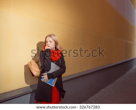 Portrait of a young student girl  holding exercise books.
