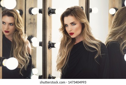 Portrait of young stunning woman with a beautiful makeup and hairstyle