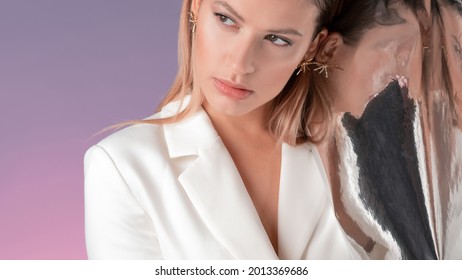 Portrait Of A Young Stylish Woman In A White Jacket And Her Distorted Reflection