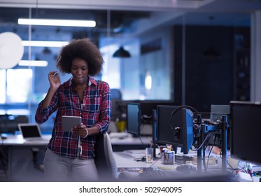 portrait of a young successful African American beautiful woman who enjoys spending a quality and joyful time while working in a large modern office - Shutterstock ID 502940095