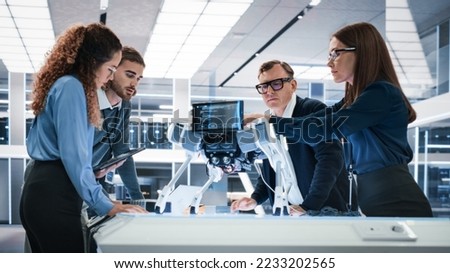 Portrait of a Young Team of Multicultural Engineers Use Computers, Connect Microchips, Analyze and Discuss How a Futuristic Robot Dog Works. High Tech Research Laboratory with Modern Equipment.