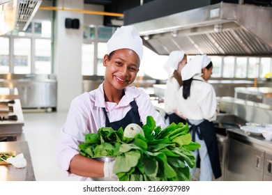 Portrait Young Teen Girl Cook Student. Cooking Class. Culinary Classroom. Happy Young African Woman Students Holding Fresh Vegetables For Cooking In Cooking School. 