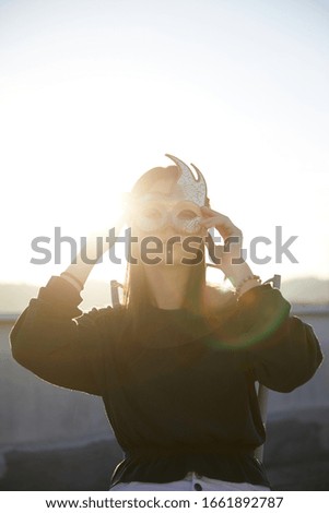 Similar – Blonde woman with black dress and sunglasses performing dance in nature with backlight