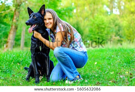 Similar – Pretty blond woman with her two dogs