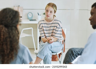 Portrait Of Young Teenage Girl In Support Group Circle Listening To Kids Sharing Story In Mental Health Therapy