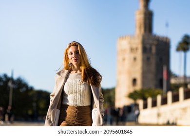 Portrait Of Young Teenage Girl Walking Down The Street With Winter Coat In Seville, Spain.