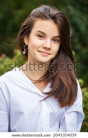Portrait of a young teenage girl in white shirt
