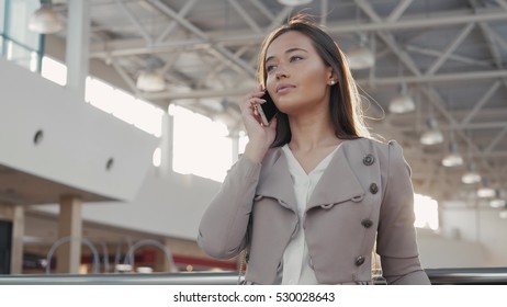 portrait of a young teenager tourist woman visiting the city shopping using her smartphone device and smiling. Business  in airport