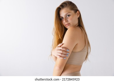 Portrait Of Young Tender Girl With Freckles And Natural Fair Hair Posing Isolated Over Grey Studio Background. Femininity. Concept Of Beauty, Body And Skin Care, Health, Plastic Surgery, Cosmetics, Ad