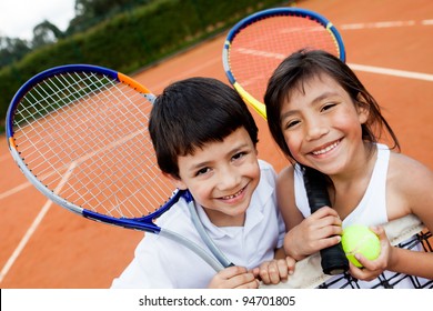 Portrait of young tennis players smiling at the court
