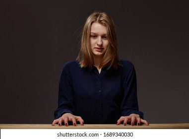 Portrait Of Young Tense Depressed Woman At Table