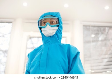 Portrait Of Young Tired African American Medical Worker Or Nurse In Protective Gear And Face Mask And Looking At Camera With Frustrated Expression. Healthcare Workers During COVID-19 Pandemic