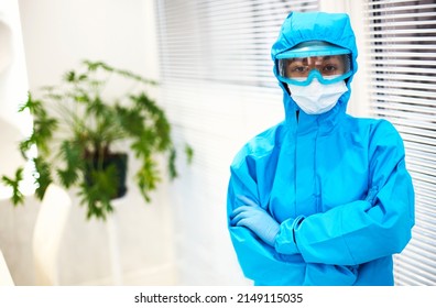 Portrait Of Young Tired African American Medical Worker Or Nurse In Protective Gear And Face Mask And Looking At Camera With Frustrated Expression. Healthcare Workers During COVID-19 Pandemic