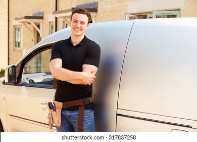 Portrait of a young tradesman by his van