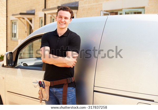 Portrait of a young\
tradesman by his van