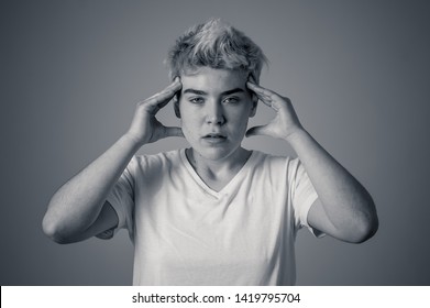Portrait of a young transgender teen looking worried and thoughtful suffering from migraines and emotional pain. People Diversity gender identity and Depression in adolescent and health care concept.